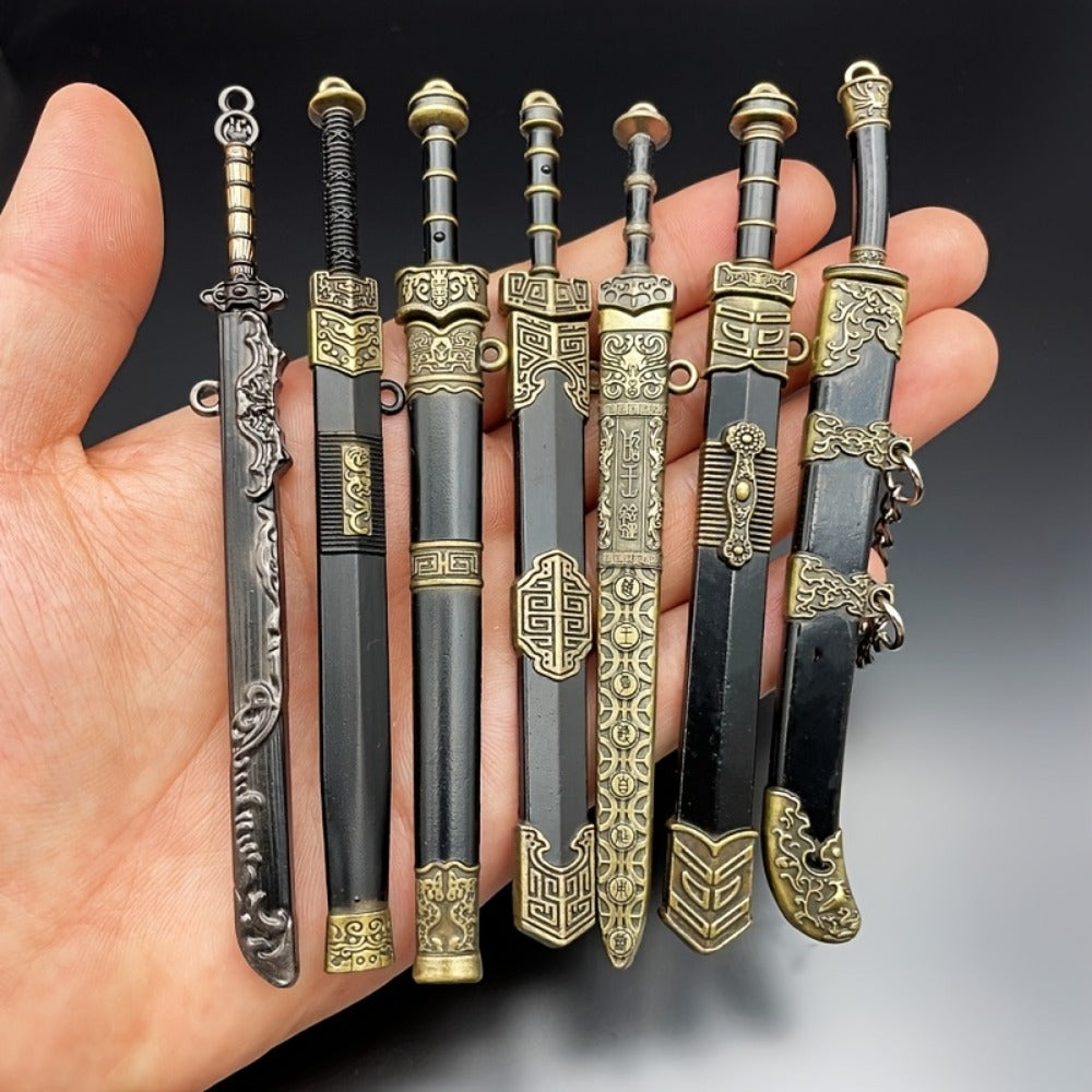 Miniature Metal Swords Set 7pcs Ancient-Inspired Collectible Pendant with Sheath – Military Theme Durable Metal Mini Sword Toy Gift for Anime Game Enthusiasts Ages 14+