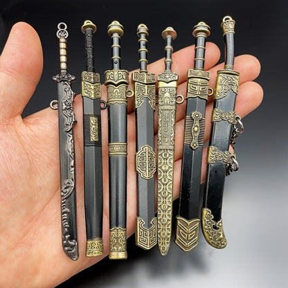 Miniature Metal Swords Set 7pcs Ancient-Inspired Collectible Pendant with Sheath – Military Theme Durable Metal Mini Sword Toy Gift for Anime Game Enthusiasts Ages 14+